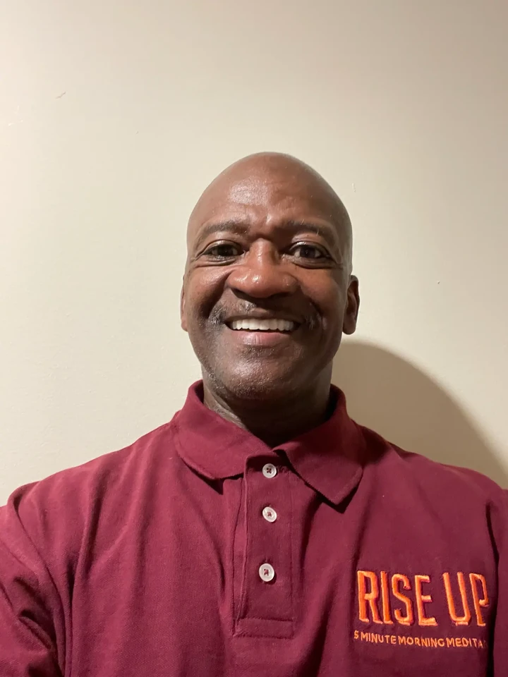 Raymond L. Matthews smiling in his Rise Up polo shirt